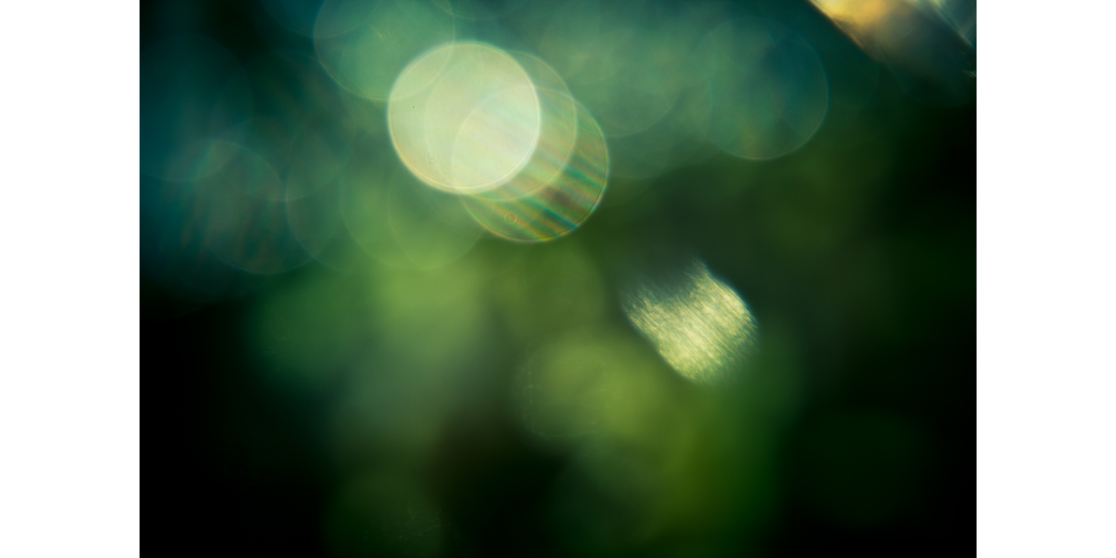 A coffee shop setting featuring a disposable coffee cup with a recognizable logo next to an open laptop displaying a calendar. The environment suggests a workspace or casual meeting place with a focus on productivity. A notebook is partially visible in the foreground, emphasizing the theme of planning or organization.